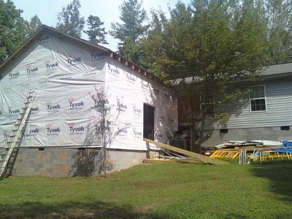 Tyvek wrapped gable on a new room addition beside an existing home in Climax